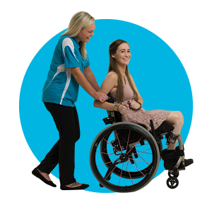 support worker walking with a young person in a wheelchair